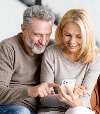 couple reviewing alerts on cell phone