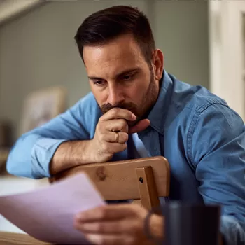 man reviewing finances in distress